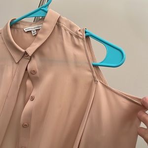 Nude, long-sleeved top with open shoulders.
